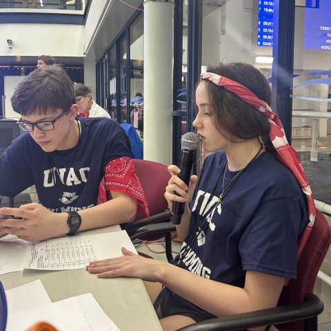 UVAC Swimmers handling the announcements at the 2025 10 And Under Championship Meet